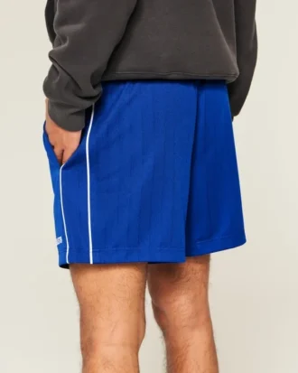 Pantalones cortos de fútbol de punto con logotipo hasta la mitad del muslo