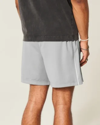 Pantalones cortos de fútbol de punto con logotipo hasta la mitad del muslo