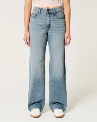 Vaqueros holgados de talle alto y lavado medio con corte curvilíneo Vaqueros holgados de talle alto y lavado medio con corte curvilíneo